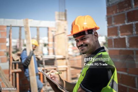 Portrait of a construction worker holding a clipboard working at a construction site