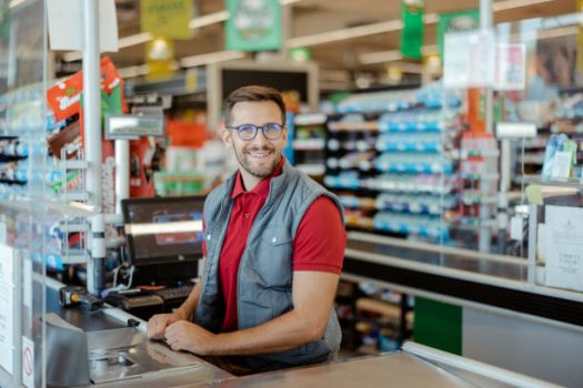 Portrait of a smiling shopkeeper in a grocery store