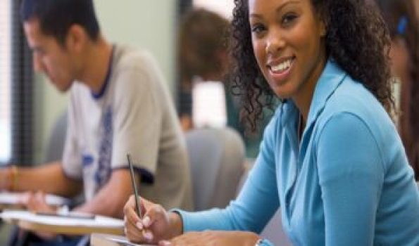 Students taking written examination, woman smiling, portrait