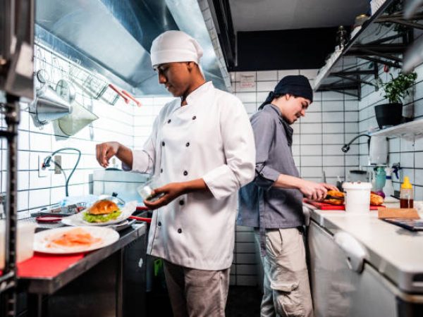 Chef young men making sandwiches on a commercial kitchen
