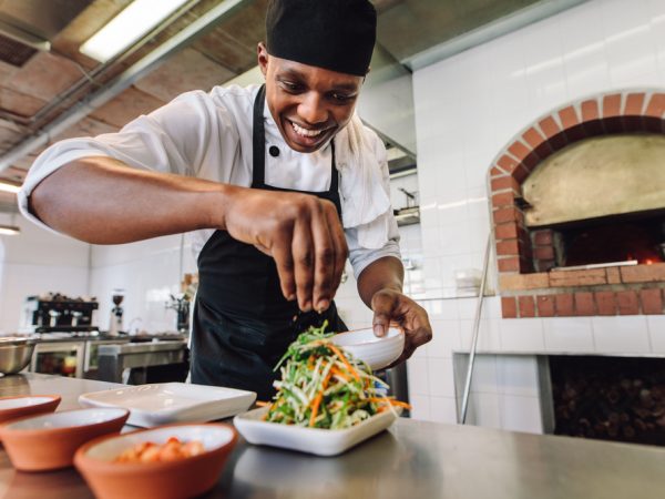 Male,Chef,Preparing,Salad,In,Kitchen.,Gourmet,Chef,Making,Delicious