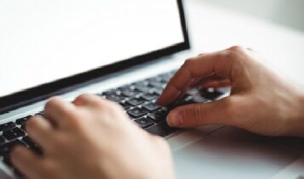 Woman using laptop in cafÃ©