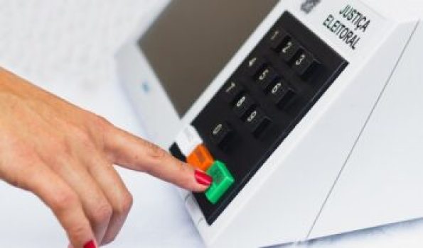 November 16, 2020, Brazil. In this photo illustration a woman simulates a vote in the electronic ballot box used in the elections of Brazil